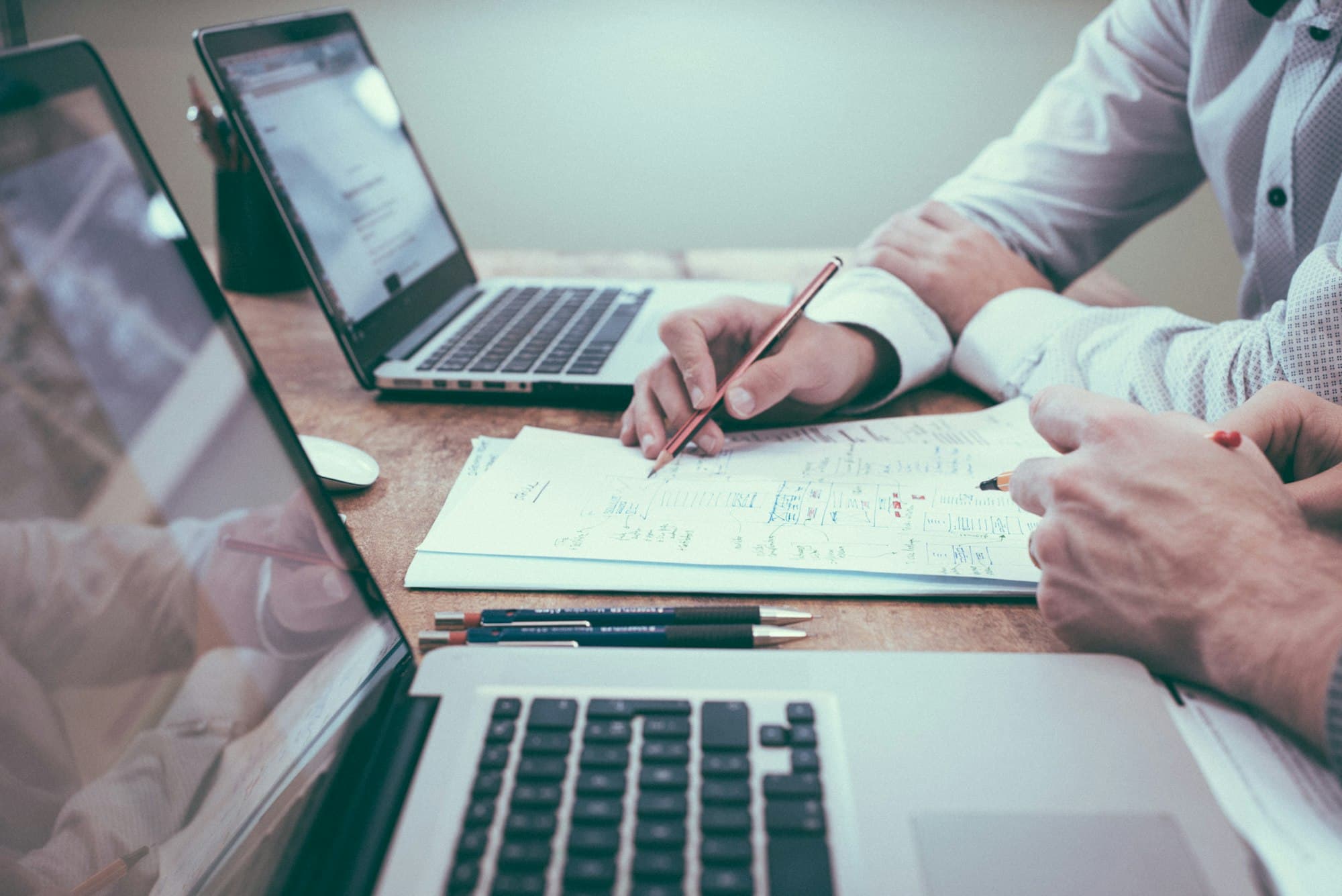 Professional reviewing grant proposal documents at a desk